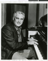 Photograph of Charlie Rich seated at a piano, circa 1968