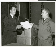 Black-and-white photograph of a Sands Hotel employee receiving a certificate of merit, Las Vegas, October 3, 1968