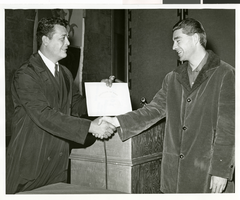 Black-and-white photograph of a Sands Hotel employee receiving a certificate of merit, Las Vegas, October 3, 1968