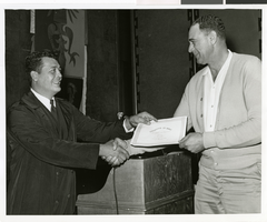 Black-and-white photograph of a Sands Hotel employee receiving a certificate of merit, Las Vegas, October 3, 1968