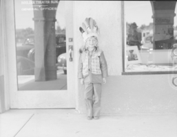 Film transparency of showing a child in front of Boulder Dam Service Bureau Building, Boulder City, Nevada, circa 1932-1940s