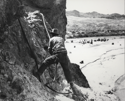 Photograph of a man working construction on a cliff near Black Canyon, Nevada, circa 1931