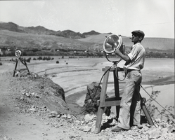 Photograph of a man working construction on a cliff near Black Canyon, Nevada, circa 1931