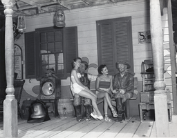 Photograph of two women posing with statues at the Frontier Museum and Saloon, Las Vegas, circa 1950s