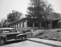 Photograph of a woman posing in front of the Lake Mead Lodge, Nevada, circa 1940s to 1950s
