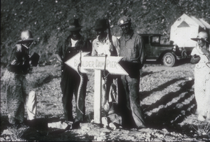 Slide of people at the Hoover Dam pier sign, April 18, 1931