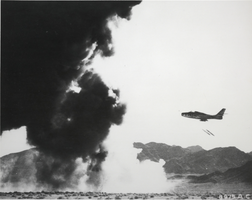 Black-and-white photograph of an F-84 fighter-bomber aircraft at Nellis Air Force Base, Nevada, circa early 1950s