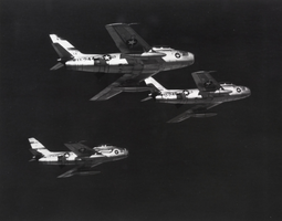 Black-and-white photograph of F-86 fighter aircraft over Nellis Air Force Base, Nevada, circa 1952