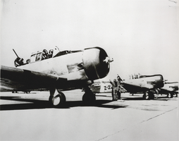 Black-and-white photograph f a T-6 trainer aircraft on land, Las Vegas Flexible Gunnery School, Nevada, circa early 1940s