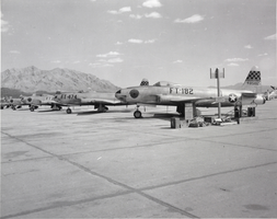 Black-and-white photograph of aircraft at Nellis Air Force Base, circa 1950s