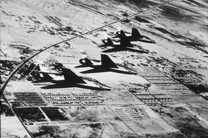Slide of F-100 fighter aircract in flight over Nellis Air Force Base, Las Vegas, mid 1950s