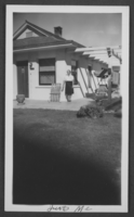 Black-and-white photograph of Mayme Stocker in front of her house, Las Vegas, Nevada, August 13, 1947