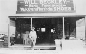 Film transparency of a man in front of Will Beckley Men's Furnishing, Goodsprings, Nevada, circa early 1900s