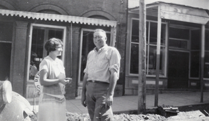 Photograph of people outside of an unidentified building, circa 1920-1940s