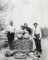 Photograph of Stewart family members with a basket collection, circa 1910s