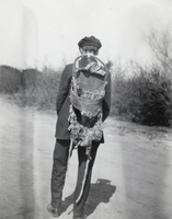 Photograph of a man with a cradle on his back, circa early 1900s
