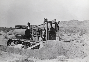 Photograph of a worker using heavy equipment at the Hoover Dam construction site, 1931
