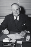 Photograph of Louis R. Douglas signing a document, January 27, 1954