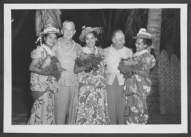 Photograph of Harold Stocker with Hawaiian dancers, Waikiki, Hawaii, circa 1950s