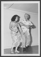 Photograph of Harold Stocker and a Hawaiian dancer, Waikiki, Hawaii, circa 1950s