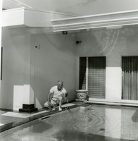 Black-and-white photograph of Wilbur Clark at the Roman Pool at his residence, Las Vegas, Nevada, 1955.