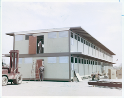 Photograph of a prefabricated dormitory being assembled at Nellis Air Force Base, Nevada, circa 1960s-1970s