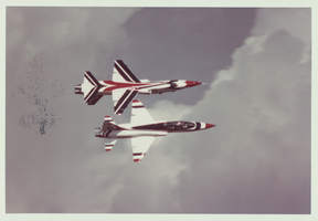 Photograph of two Thunderbirds planes performing aerial stunts, 1980