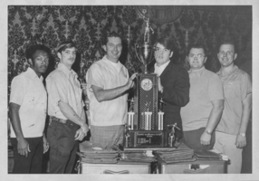 Black-and-white photograph of the Nellis Bowling Team after winning a military bowling competition, Las Vegas, Nevada, February 9, 1974
