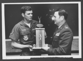 Black-and-white photograph of Technical Sergeant Frederick Joyner and Colonel William Strand, Nellis Air Force Base, Nevada, January 26, 1976