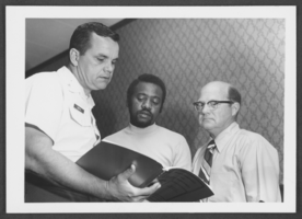Photograph of Colonel Harold Dortch and two businessmen at a small business seminar at Nellis Air Force Base, Nevada, May 26, 1976