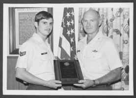 Black-and-white photograph of Sergeant Russell Gagnon accepting award from Brigadier General James Hildreth, Nellis Air Force Base, Nevada, July 26, 1976