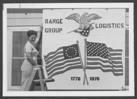 Photograph of Yvonne Farewell holding a U.S. bicentennial sign, Nellis Air Force Base, Nevada, July 2, 1976