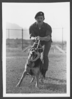 Photograph of Sergeant Bradley Marshall and a police dog, Nellis Air Force Base, Nevada, October 10, 1979