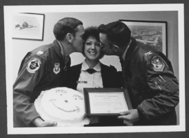 Black-and-white photograph of Airman Sharon Helfin receiving a certificate from the 474th Tactical Fighter Wing, Nellis Air Force Base, Nevada, December 7, 1978