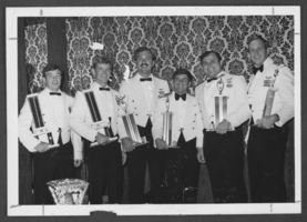 Black-and-white photograph of military personnel with trophies, Nellis Air Force Base, Nevada, September 18, 1975
