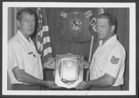 Black-and-white photograph of military personnel with a safety award, Nellis Air Force Base, Nevada, August 8, 1974