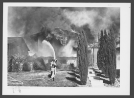 Photograph of firemen fighting fire, North Las Vegas, March 13, 1980