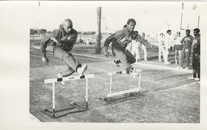 Photograph of Rancho High School track team members leaping hurdles, North Las Vegas, Nevada, 1971