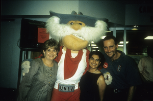 Slide of people posing with University of Nevada, Las Vegas mascot, circa 1990s