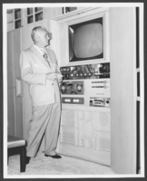 Black-and-white photograph of Wilbur Clark in front of his closed-circuit television in his living room, Las Vegas, Nevada, circa 1950s