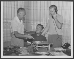 Black-and-white photograph of Wilbur Clark, Errol Flynn and Ralph Stone, location unknown, circa 1950s