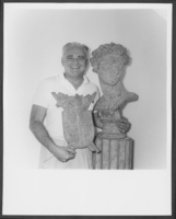 Black-and-white photograph of Wilbur Clark and statue, Las Vegas, 1955