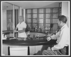 Black-and-white photograph of Wilbur Clark and guest, Las Vegas, circa mid 1950s