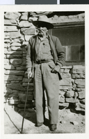 Photograph of Tweed Wilson standing in front of a stone house in Las Vegas, Nevada, circa 1952-1953