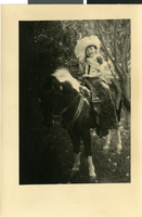 Photograph of a child on horseback, circa early 1900s