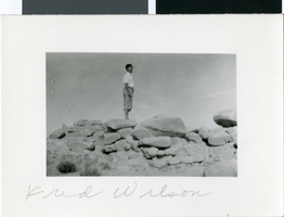 Photograph of Fred Wilson standing on rocks, Nevada, circa 1920s to 1940