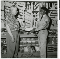 Photograph of Ed Von Tobel, Sr. making a presentation to a Nellis A. F. B. airman, Las Vegas, July, 1955
