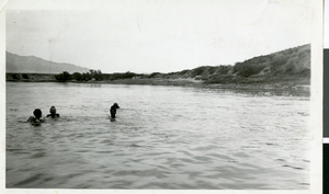 Photograph of four men trying life preservers in the Colorado river, circa 1930s
