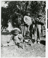 Photograph of four Indian children in front of cottonwood tree, Pahrump Valley, Nevada, circa 1880s-1890s