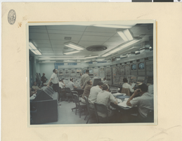 Photograph of employees standing next to test site equipment in Nevada, Circa 1960